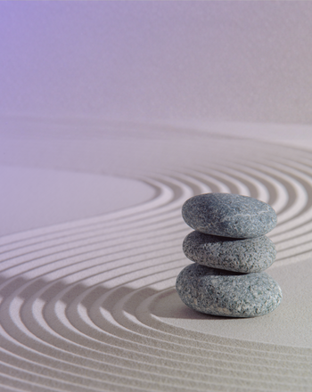 Raked sand with stones stacked