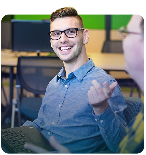 two workers talking and smiling