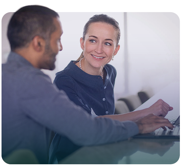 two workers talking and smiling