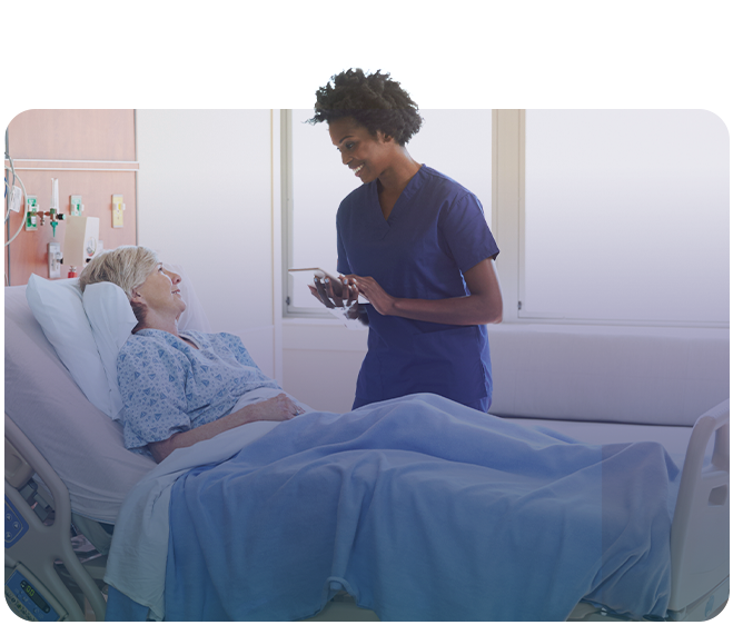 Healthcare worker caring for a patient in a hospital bed