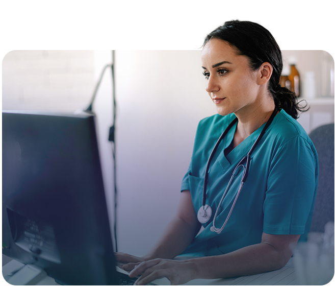 Healthcare worker typing on a computer
