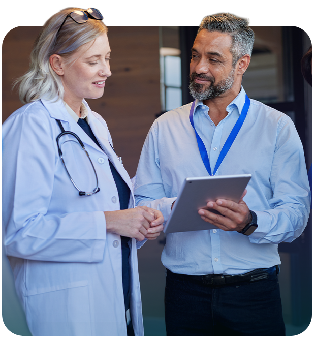 two healthcare workers looking at a tablet