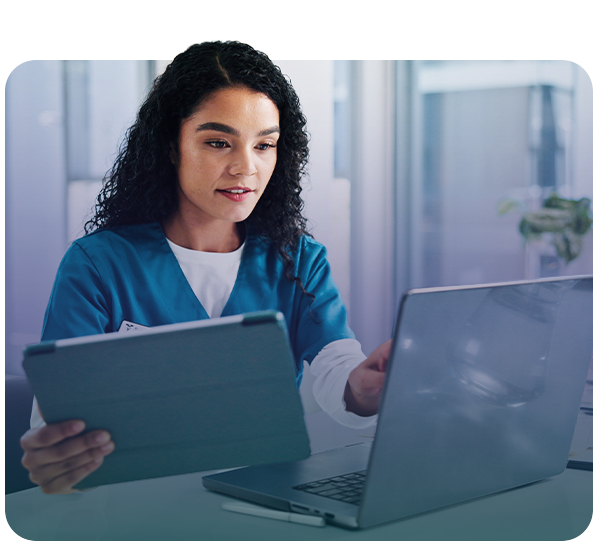 Doctor or nurse looking at laptop and tablet