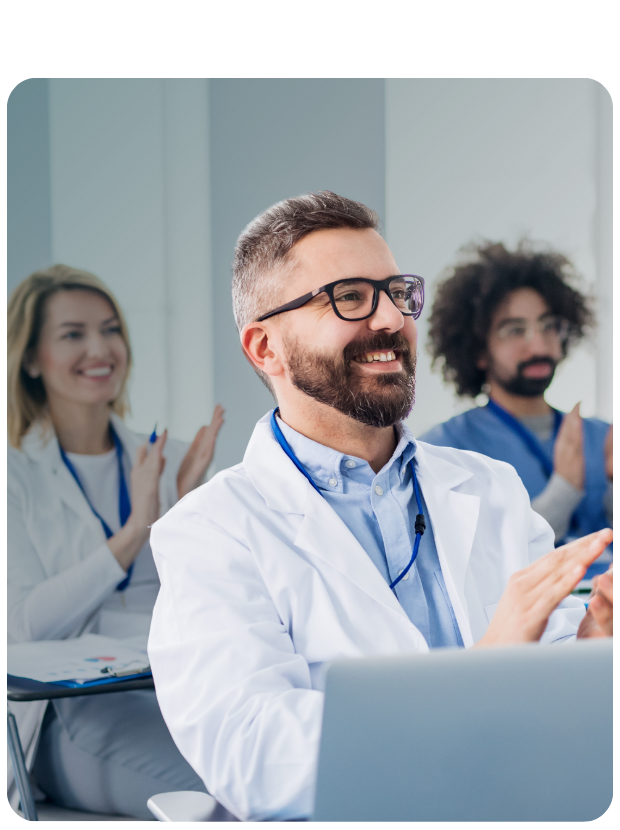 Three clinicians clapping while seated