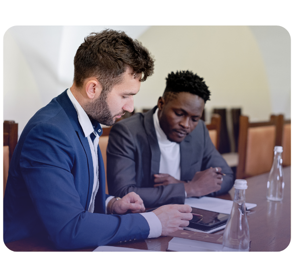 Two businessmen reviewing info on tablet