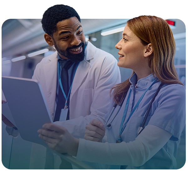 Two clinicians talking while using a tablet
