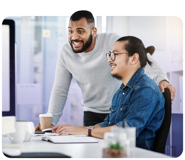 Two men in office setting smiling