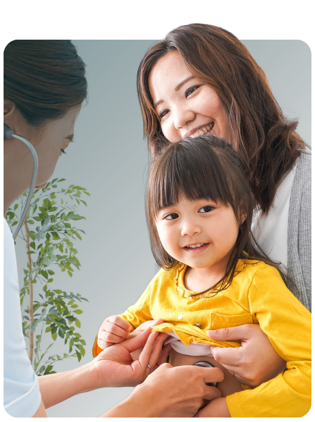 Mom holding child while clinician uses stethoscope
