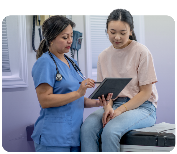 Female clinician using tablet with female patient