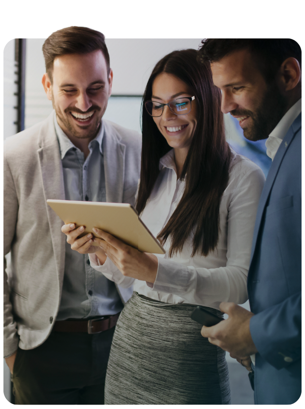 Smiling business associates looking at tablet while standing
