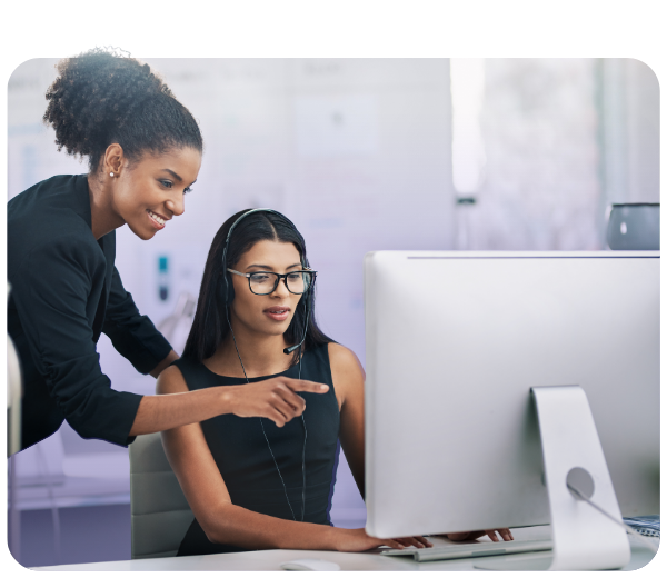 Two women looking at a large monitor