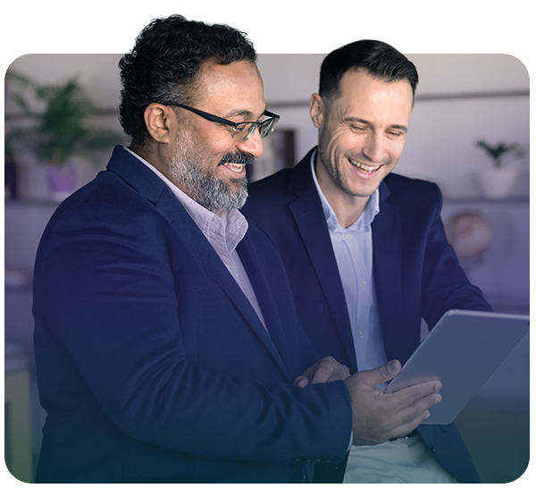 two professionals in meeting looking at tablet