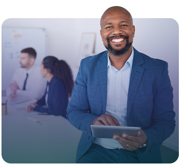 man smiling at camera holding tablet