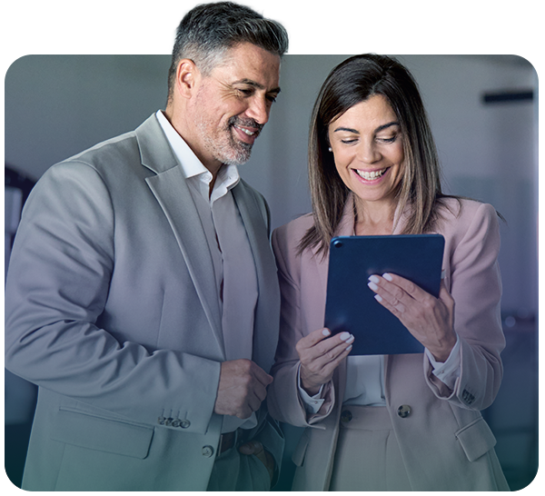 Business professionals smiling while looking at tablet