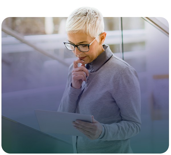 Concerned looking woman reading tablet