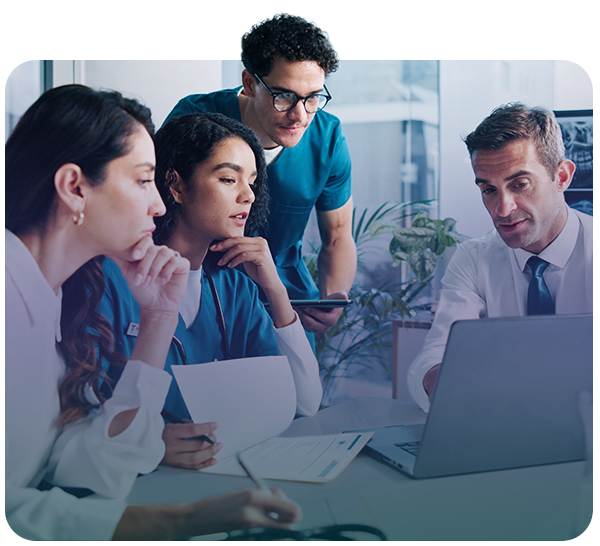 Clinicians and business associates looking at laptop