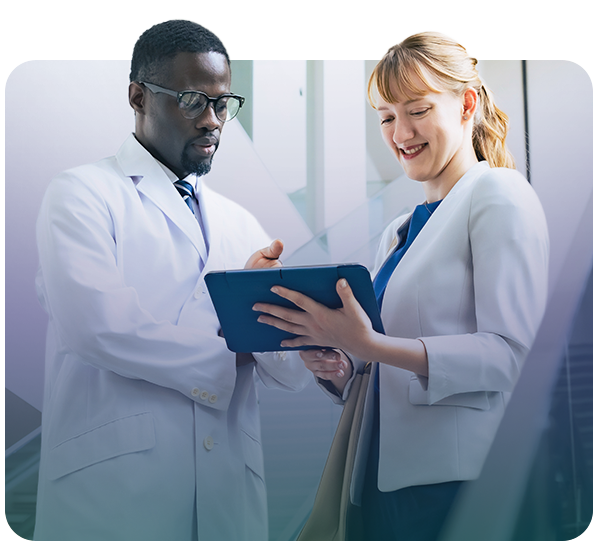 Male clinician having a discussion with female associate holding tablet