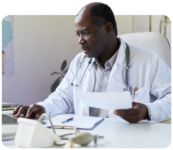 Male clinician working on laptop at desk