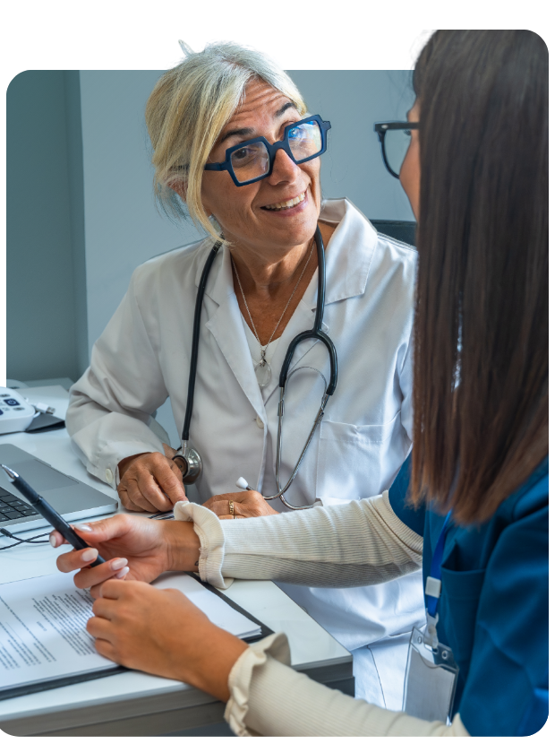 Two clinicians sitting at desk and smiling