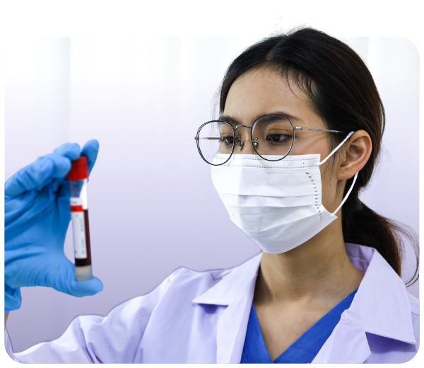 Woman in medical mask and gloves holds vial of blood