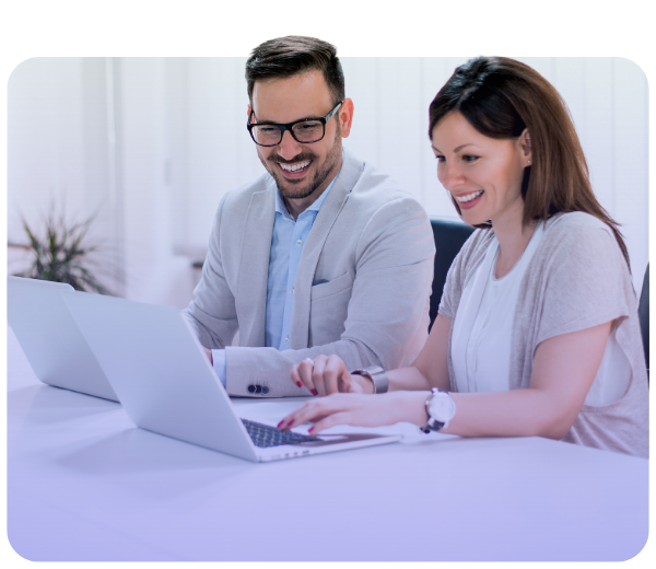 man and a woman looking at a computer and smiling